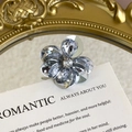 Macro detail of silver flower shoe charm with sparkling crystal rhinestones on a mirror - Gray-Blue Transparent Crystal Flower Style (27059-37)