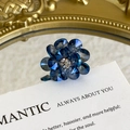 Detailed macro shot of dark blue crystal flower shoe charms with central rhinestone - Dark Blue Cut Crystal Flower Style (27059-42)