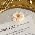 Detail of a handmade white beaded flower charm with an orange center for DIY shoe clogs - White with Orange Center Beaded Style (27059-51)