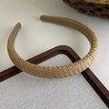 Close-up of bohemian woven straw headband with detailed texture on linen tray - Light Brown Twill (5# 25583B)
