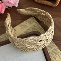 Detail of hollow woven beige headband showing straw texture and khaki ribbon ends - Natural Beige