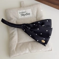Elegant black satin polka dot bow hair clip with gold logo detail on beige fabric - Black With White Polka Dots
