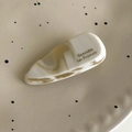Detail of cream marble acetate teardrop hair clip on a minimalist ceramic plate - Clear Multicolor