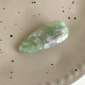 Close-up of light green marble acetate waterdrop hair clip with gold lettering - Green Multicolor
