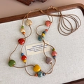 Colorful ceramic heart bead necklace with bohemian style on a rustic wooden tray - Main Style