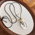 Detail of minimalist geometric rings on black wax cord adjustable long necklace - Matte Silver