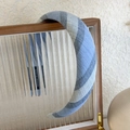 Detailed close-up of blue striped sponge headband on a vintage glass jewelry box - Blue Gray Stripe