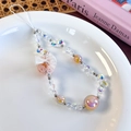 Dettaglio del cinturino da polso per telefono con perline aurora e fiocco in organza - Stile Arancione (26456C)