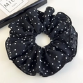 Detail view of oversized black and white polka dot chiffon scrunchie on a white surface - Black Polkadot (26481B)