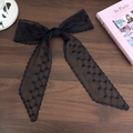 Close-up of black lace bow hairband with delicate floral patterns and long flowing ribbons - Black Heart Striped Style