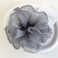 Détail macro du chouchou en organza gris avec bords volantés argentés sur une assiette - Gris Clair (26548H)