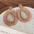 Detail of bohemian hollow teardrop woven straw earrings with gold alloy beads - Coffee