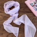 Detail of light purple sheer chiffon scarf with rolled edges on a wood background - Purple