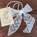 Elegant white lace bow headband with pearl necklace detail on a dark wooden background - Small Floral Lace Style (26609B)
