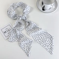 Detail shot of a long white chiffon scarf with black polka dots and tapered ends - White Base (Black Polka Dot)