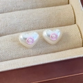 Close-up of heart-shaped pearl earrings with pink floral details in a jewelry box - Pink Shell (26657B)