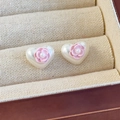 Detailed macro view of heart-shaped pearl earrings with small pink flower and resin texture - Pink Flower (26657C)