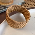 Macro detail of natural woven rattan napkin ring with intricate artisanal texture on ceramic - Fine Woven Flat Wide (26684E)