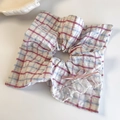 Close-up of a pink plaid scrunchie with white lace trim and a delicate ribbon bow decoration - Pink Plaid Square Hair Tie
