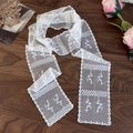 Detail shot of white lace floral ribbon scarf with wavy edges on a wooden surface - Double Flower Branch (26737F)