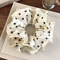 Macro view of cream silk scrunchie with black polka dots on a display tray - Beige Black Polka Dot