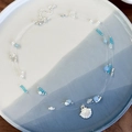Close-up of ocean-style triple-strand necklace with blue beads and silver shell charm - Shell Style (26789A)