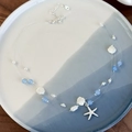 Close-up of ocean-themed necklace with blue crystal beads, starfish pendant, and shell detail - Starfish Style (26789B)
