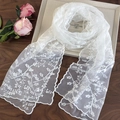 Detailed view of white floral lace embroidery and elegant scalloped edges on the scarf - White