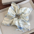 Detail of floral scrunchie with light blue ribbon bow and central button decoration - Blue Floral Square Style