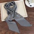 Detail of black and white checkerboard silk scarf with floral pattern on a tray - Black and White Plaid