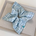Detail of blue and white plaid hair scrunchie with a floral button and handmade woven label - Blue Square Style