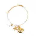 Gold plated shell and starfish charm bracelet with white pearls on a white background - Gold