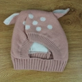 Detailed view of pink knitted baby hat with white polka dots and deer animal ears - Pink