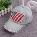 Detail view of the American flag rhinestone patch and sparkling brim on the denim cap - One Size / Light Grey Denim