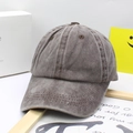 Close-up of vintage washed cotton kids baseball cap showing reinforced seams and stitching - Coffee