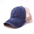 Detailed close-up of washed navy blue cotton and breathable beige mesh trucker cap - Navy Blue