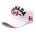 Close-up of black Canada embroidery and national flag patch on a white cotton baseball cap - One Size / White