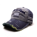Detail showing the 1969 embroidery and distressed frayed edges on a vintage baseball cap - One Size / Navy Blue