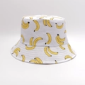 White reversible bucket hat with yellow banana pattern for sun protection and travel - One Size / White