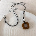 Close-up of vintage camel bone pendant with brown cracked texture and silver bead detail - Coffee Silver Bead Style (25836D)