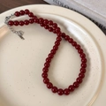 Detail of red beaded necklace with silver extension chain on a vintage porcelain plate - 8mm / 8mm Red Necklace