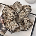 Dettaglio ravvicinato del grande elastico maculato con eleganti bordi neri cuciti - Leopardo Caffè