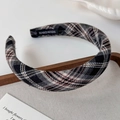 Detail eines karierten breiten Stirnbands mit handgefertigtem Etikett und Webstruktur - Schwarz Kariert