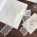 Detail shot of vintage cream lace ribbon with delicate wave edges and polka dot embroidery - 1.5m / Off-white Striped