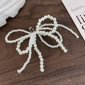Detailed view of handcrafted pearl bow shoe charm with a silver lobster clasp - 26043F 4-Loop Pearl Beaded Bow