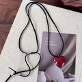 Macro detail of glossy red heart pendant with adjustable black suede rope necklace - Red Heart
