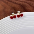 Sweet cherry stud earrings with red velvet fruit and gold leaf details on a ceramic dish - Burgundy