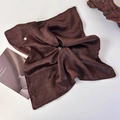 Detail of dark brown pleated satin hair scarf featuring a gold logo tag and premium rolled edges - Dark Coffee