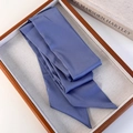 Close-up of a premium dark blue satin silk scarf folded neatly on a wooden tray - Blue (26183D)