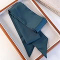 Detail of dark green satin scarf with silky texture displayed on a wooden tray - Green (26183E)